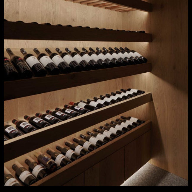 Wooden wine rack with bottles in a dimly lit room